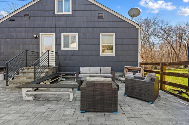 a view of a chairs and table in the back yard of the house