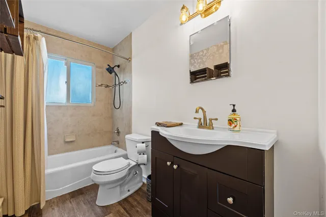 a bathroom with a sink mirror vanity and toilet