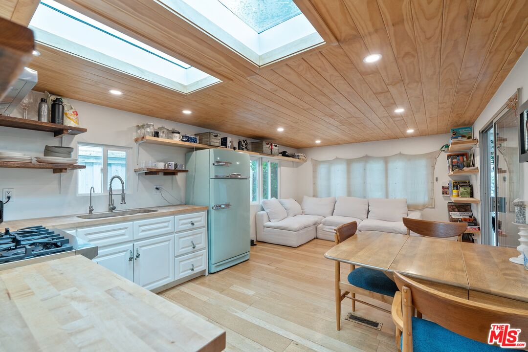 a large room with lots of wooden furniture and a wooden floors