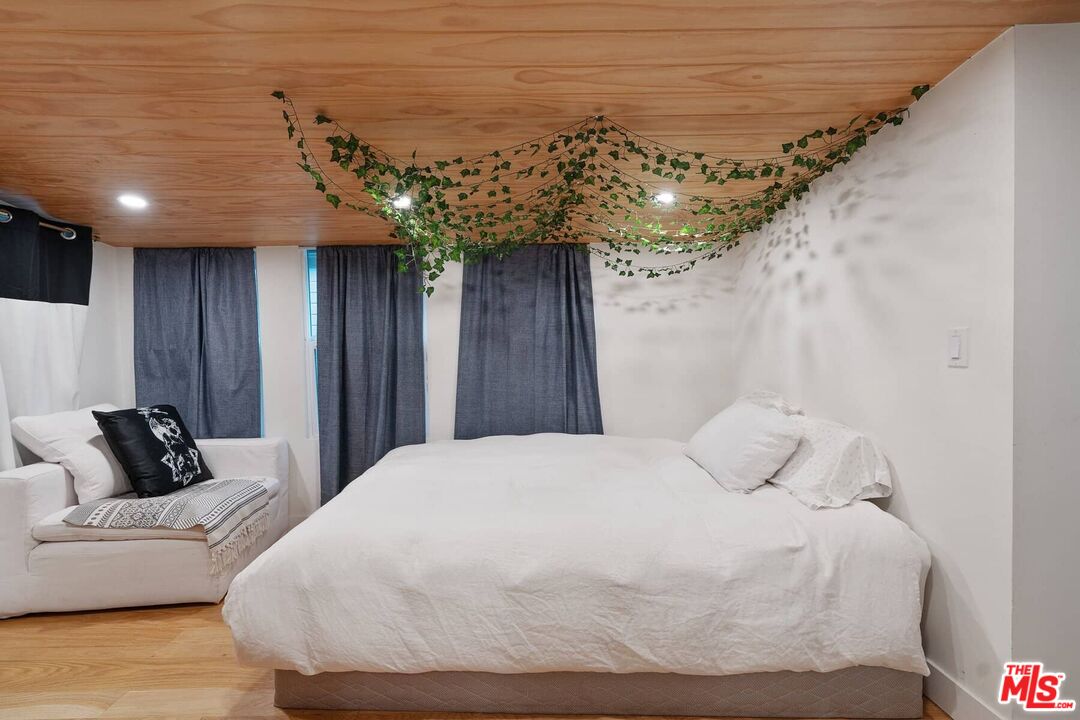 68 Paradise Cove Road Malibu, CA 90265 - Photo 6 of 28 a bedroom with a bed and a chandelier