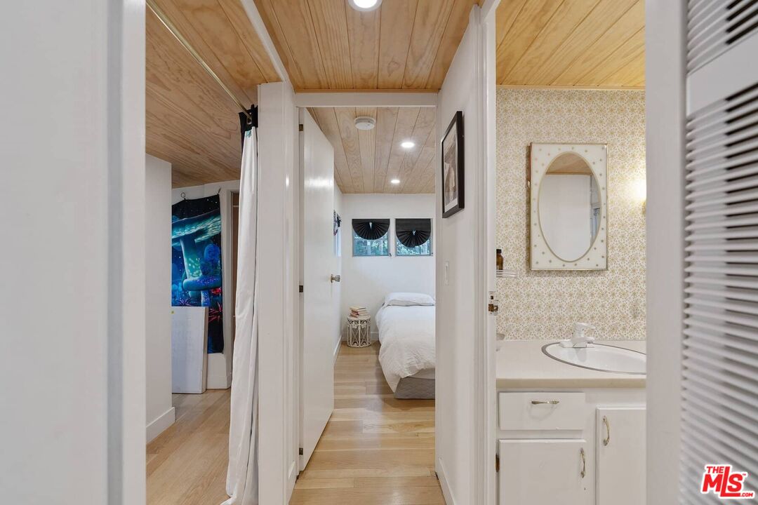 68 Paradise Cove Road Malibu, CA 90265 - Photo 8 of 28 a view of a hallway with wooden floor and a bathroom