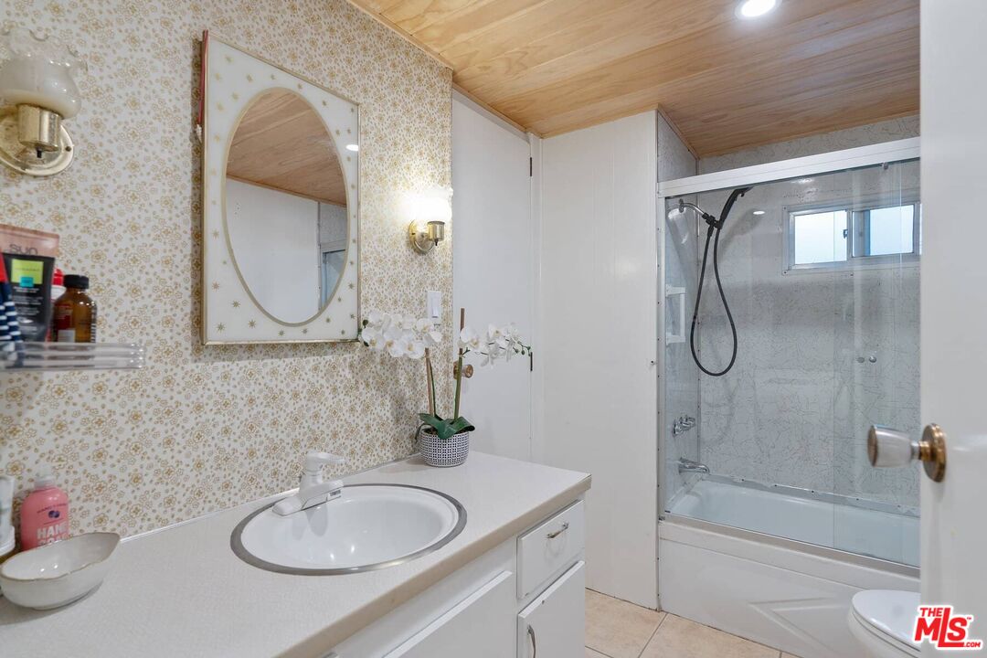 68 Paradise Cove Road Malibu, CA 90265 - Photo 9 of 28 a bathroom with a granite countertop sink mirror and a shower