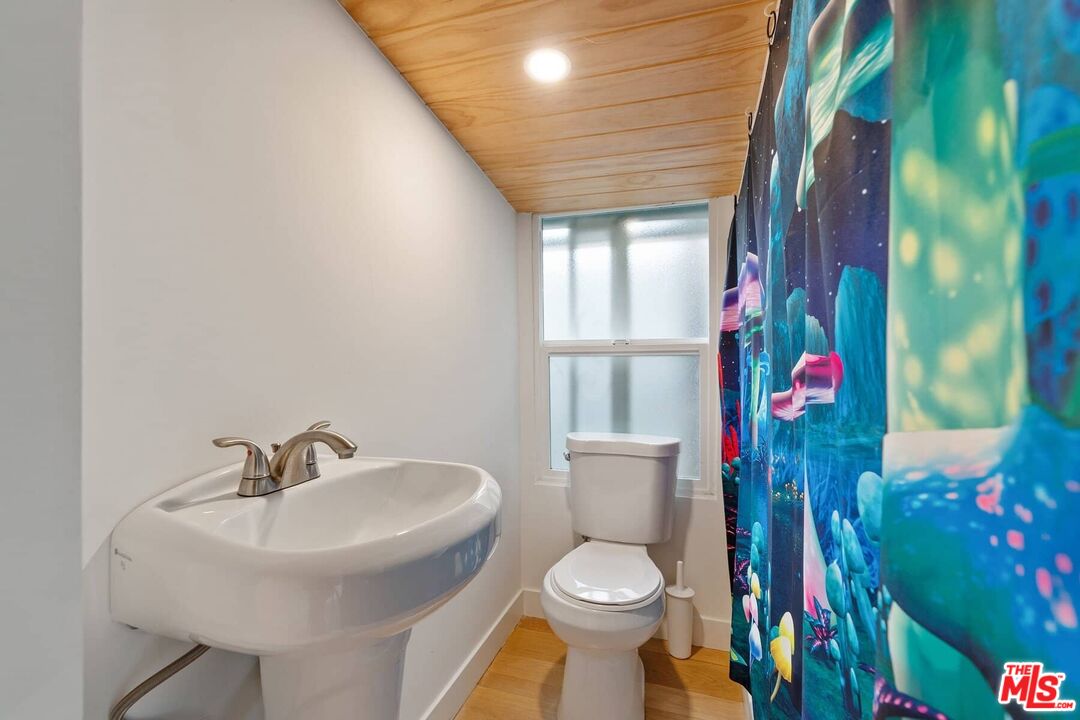 68 Paradise Cove Road Malibu, CA 90265 - Photo 10 of 28 a bathroom with a toilet sink and mirror