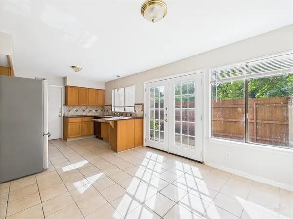 a large white kitchen with a large window