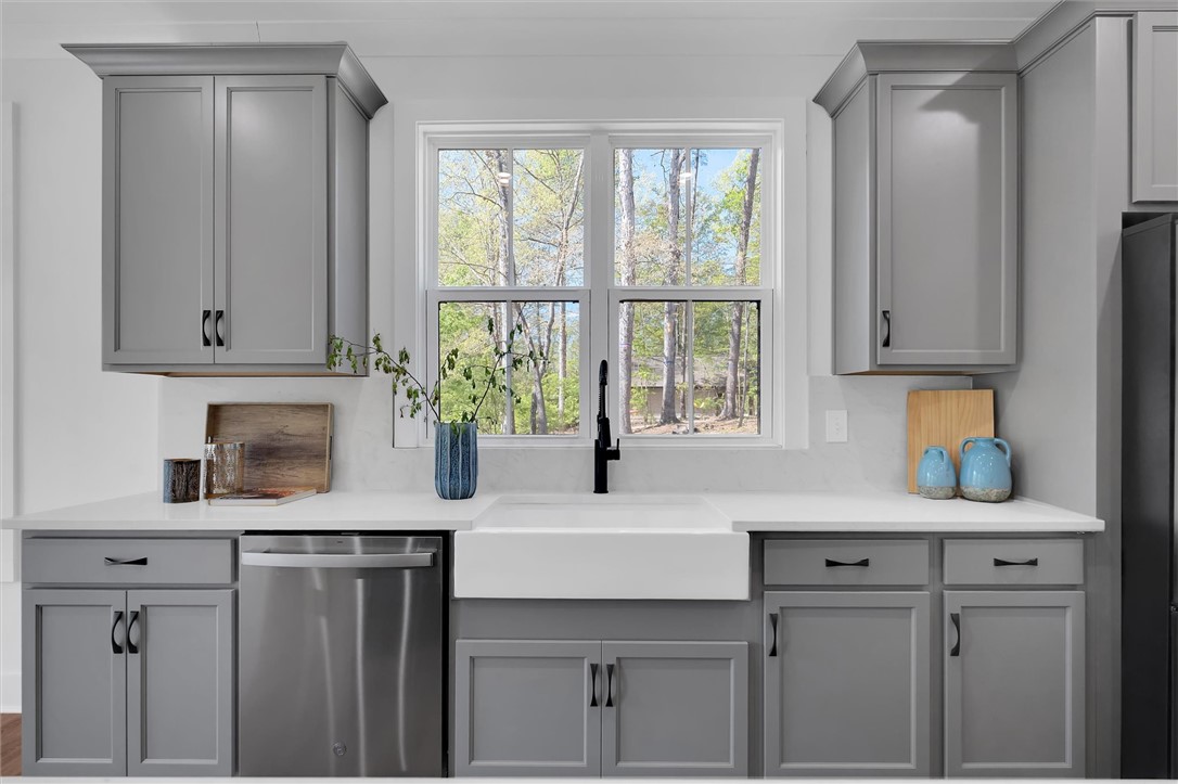 407 Blue Ridge Court Westminster, SC 29693 - Photo 13 of 48 This bright kitchen features a large window above a farmhouse sink, offering natural light.