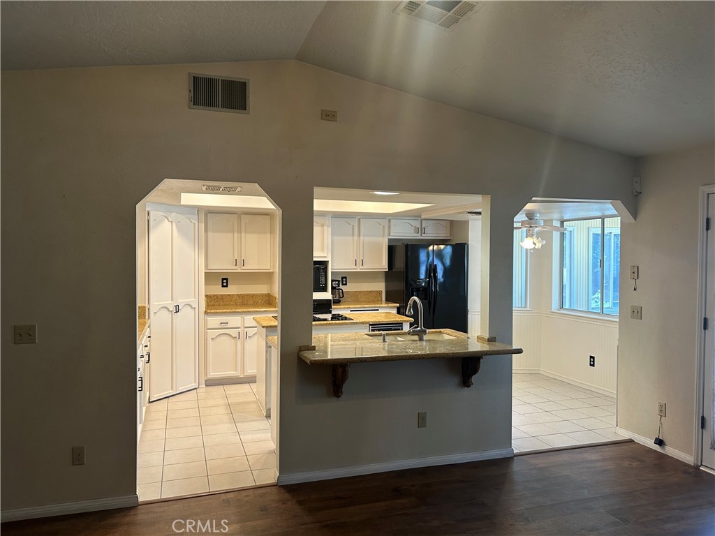 20187 Itasca Road Apple Valley, CA 92308 - Photo 20 of 35 a view of kitchen with stainless steel appliances wooden floor and living room view