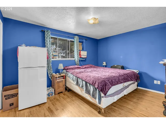 a spacious bedroom with a bed and a window