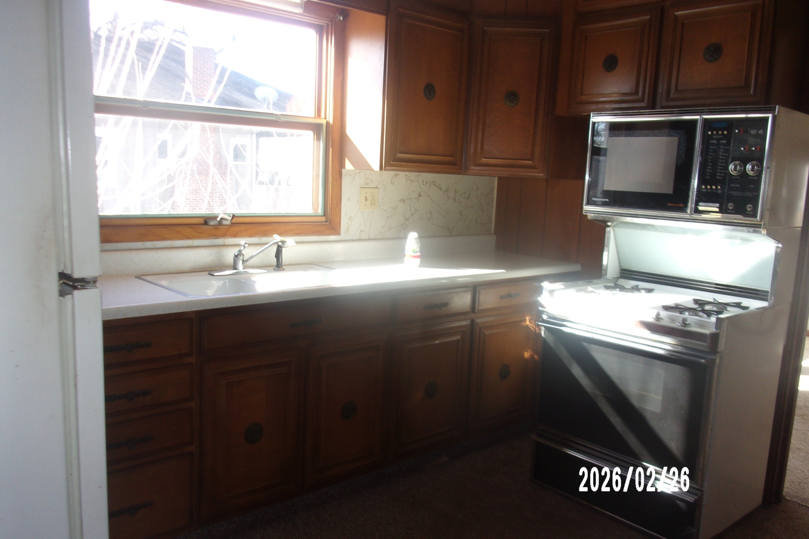 202 North Harrison Street Flanagan, IL 61740 - Photo 15 of 16 a kitchen with granite countertop a sink cabinets and window