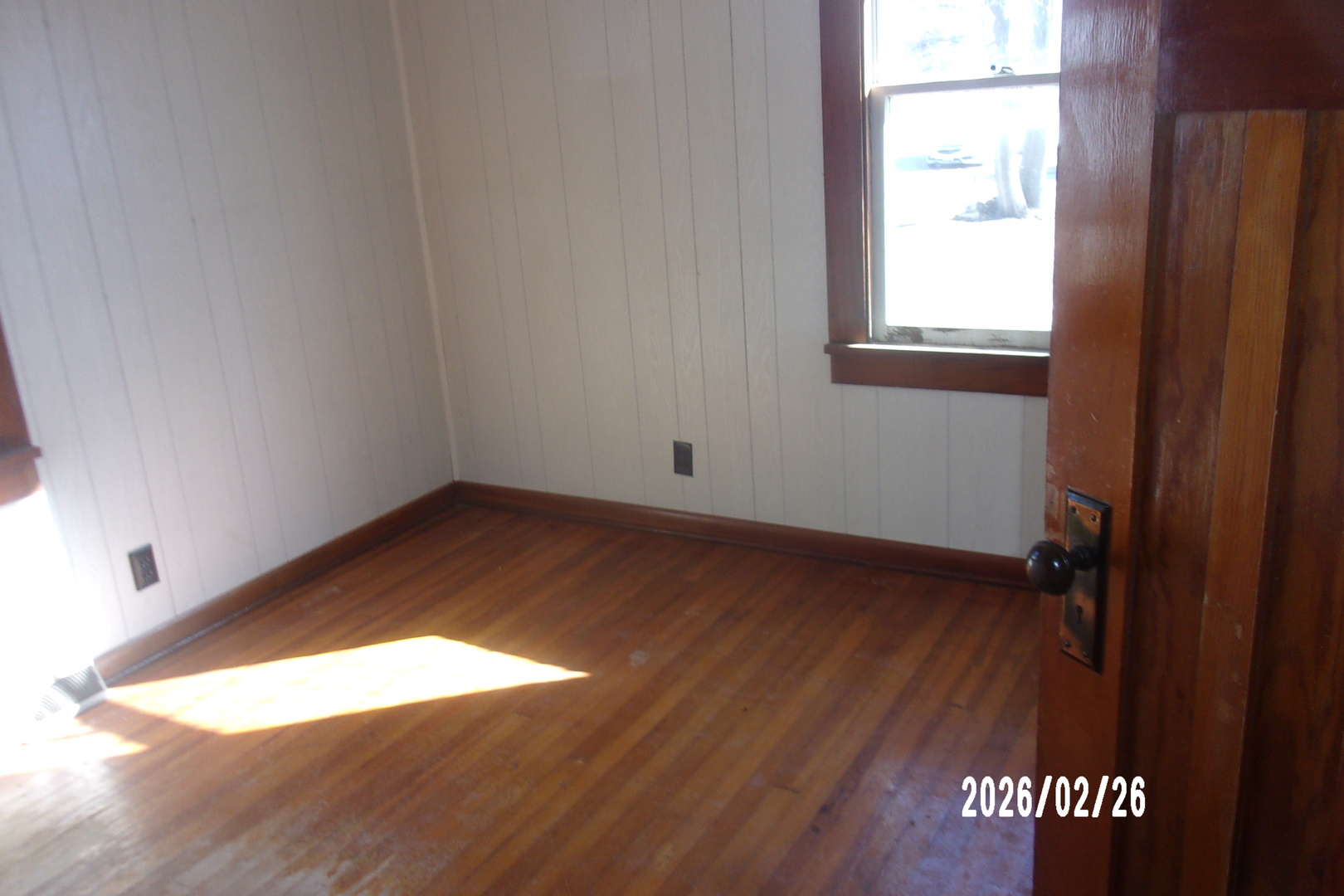 202 North Harrison Street Flanagan, IL 61740 - Photo 10 of 16 an empty room with wooden floor and windows