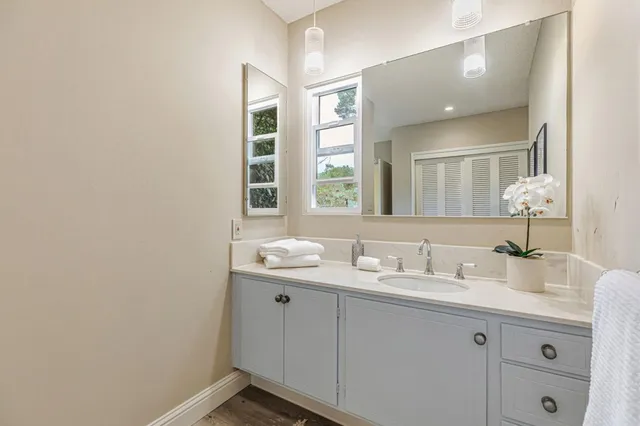 a bathroom with a double vanity sink and mirror