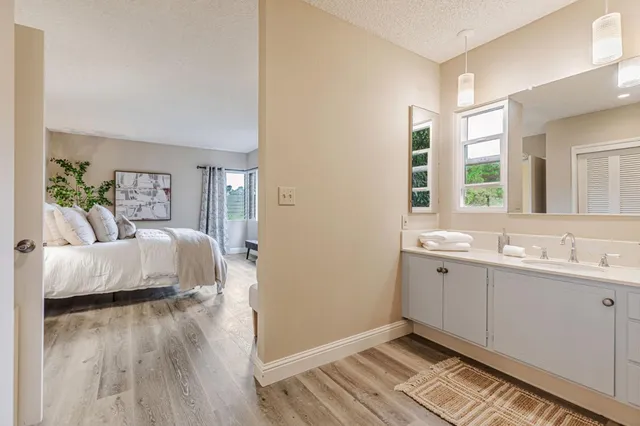 a en suite bathroom with a double vanity sink and a mirror