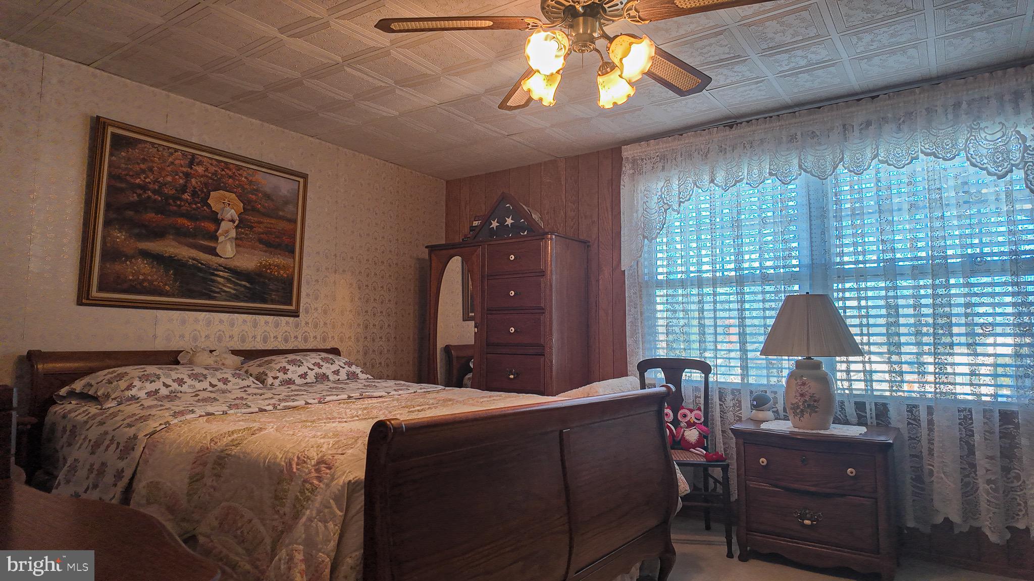 10964 Kipling Lane Philadelphia, PA 19154 - Photo 14 of 31 a bedroom with a bed and a chandelier
