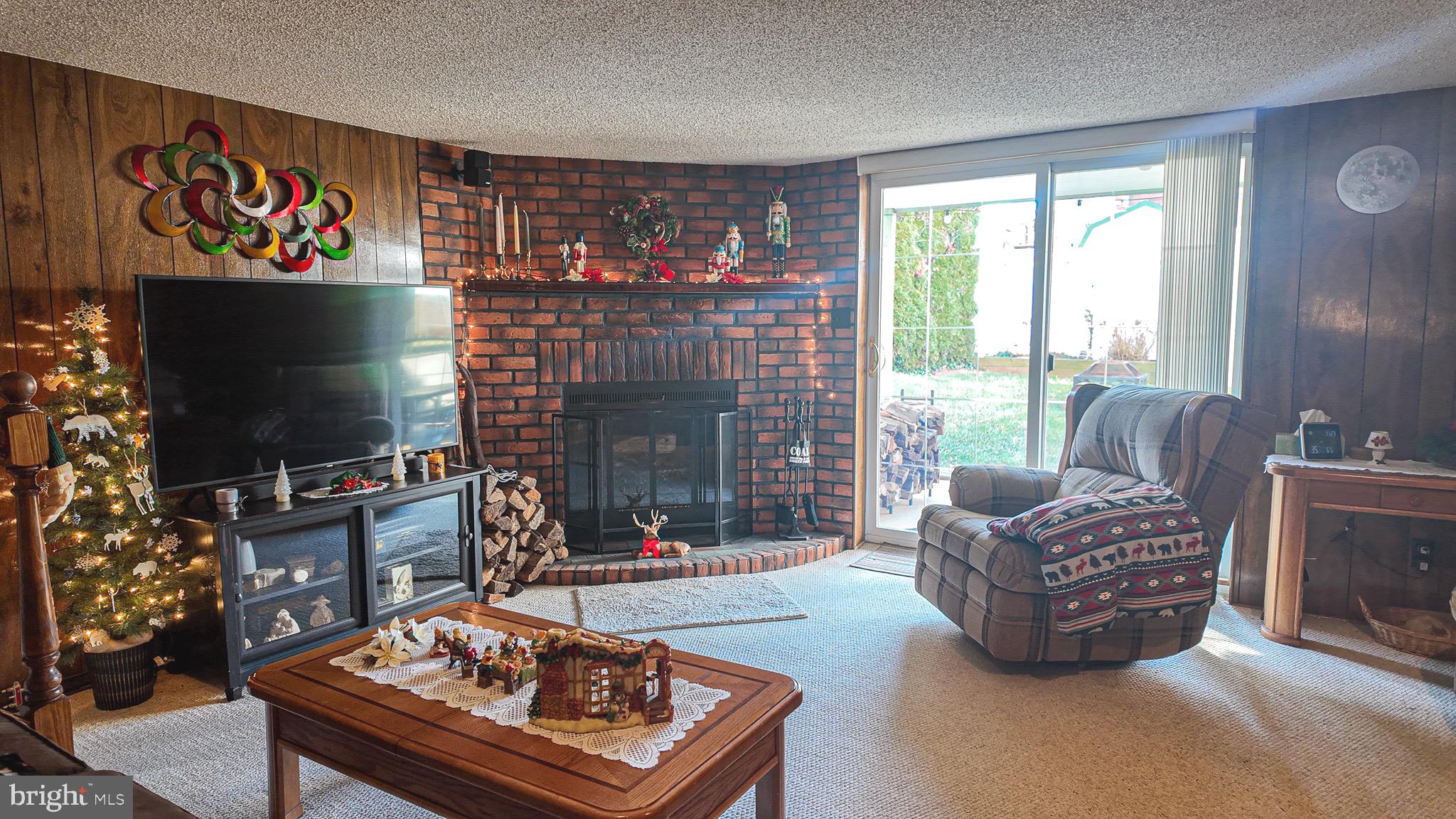 10964 Kipling Lane Philadelphia, PA 19154 - Photo 23 of 31 a living room with furniture a flat screen tv and a fireplace
