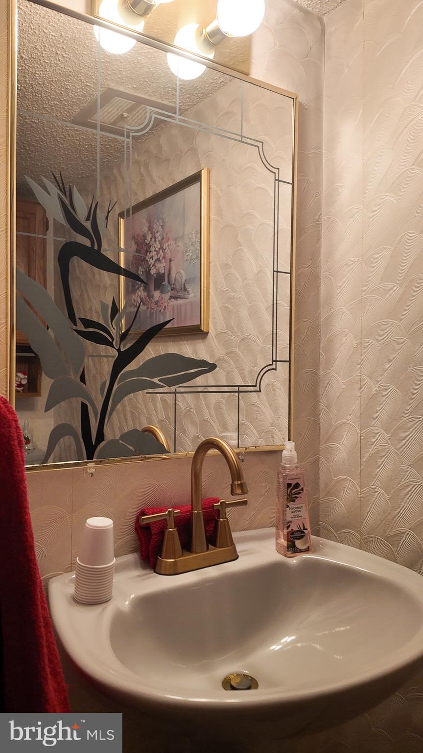 10964 Kipling Lane Philadelphia, PA 19154 - Photo 26 of 31 a bathroom with a sink and a mirror