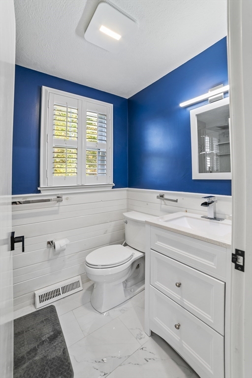 1904 Washington Street Canton, MA 02021 - Photo 21 of 39 a bathroom with a toilet sink and mirror