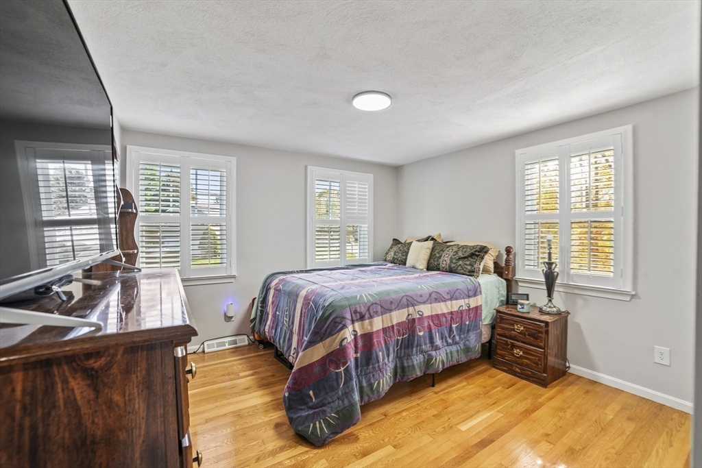 1904 Washington Street Canton, MA 02021 - Photo 25 of 39 a spacious bedroom with a bed and a couch