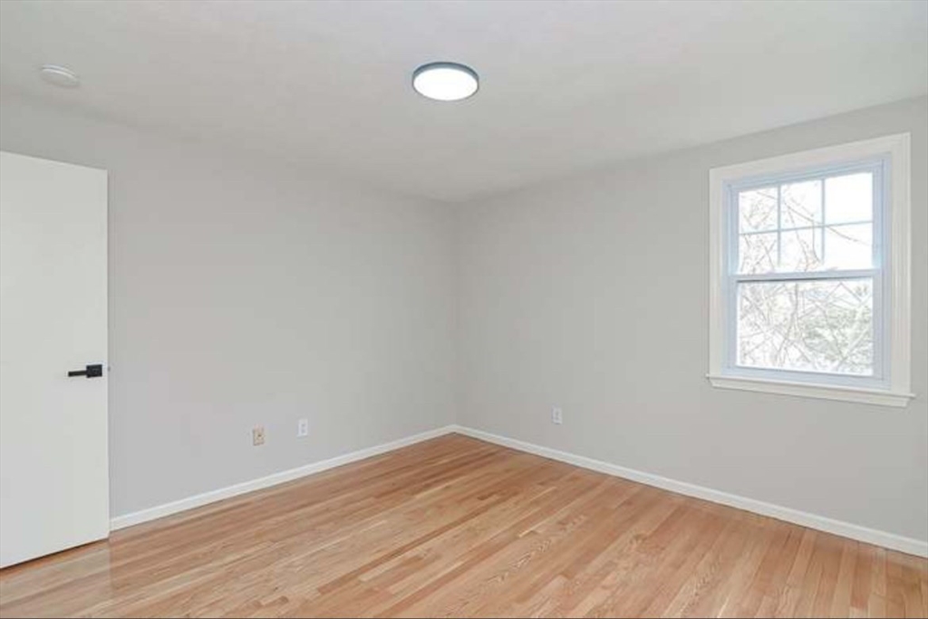 1904 Washington Street Canton, MA 02021 - Photo 26 of 39 an empty room with wooden floor and windows