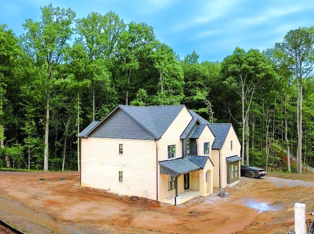 1560 Ewing Chapel Road Dacula, GA 30019 - Photo 15 of 15 a view of a house with a yard and large trees