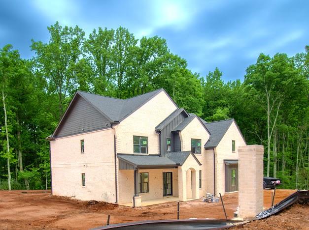 1560 Ewing Chapel Road Dacula, GA 30019 - Photo 10 of 15 a view of a white house with large windows and a small yard