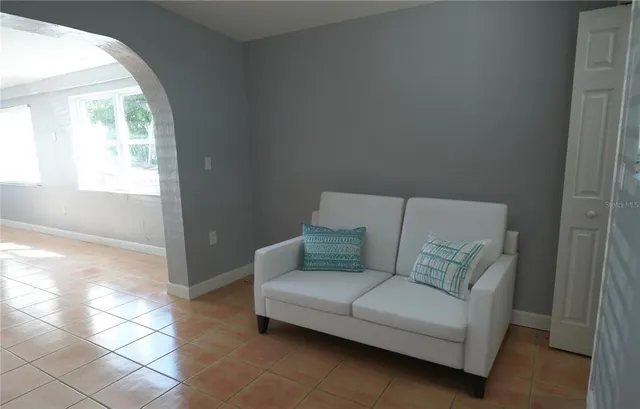 a living room with furniture and a window