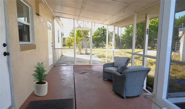 a living room with furniture and a floor to ceiling window