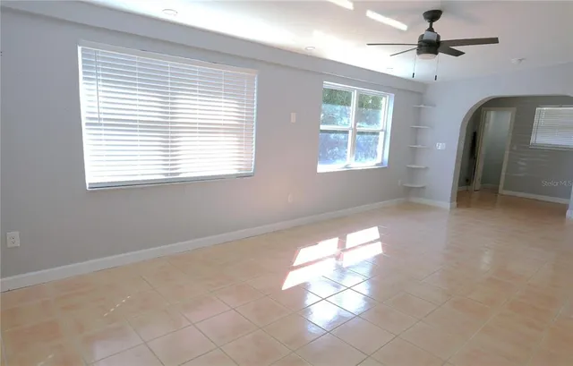 a view of a livingroom with a window and a chandelier