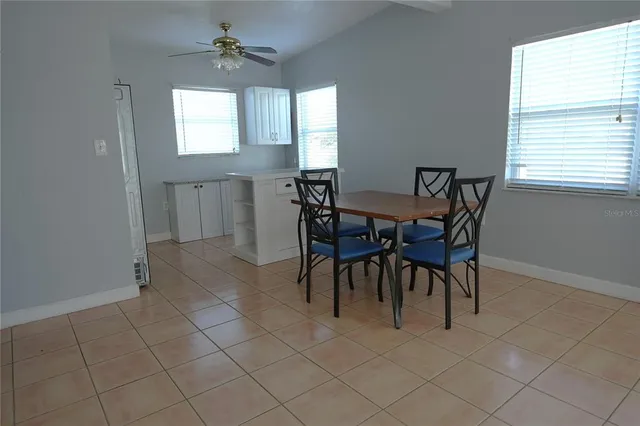 a view of a dining room with furniture and window