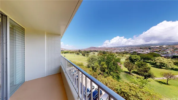 a view of a balcony with a forest
