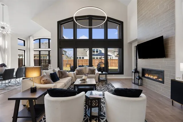 a living room with furniture a fireplace and a flat screen tv