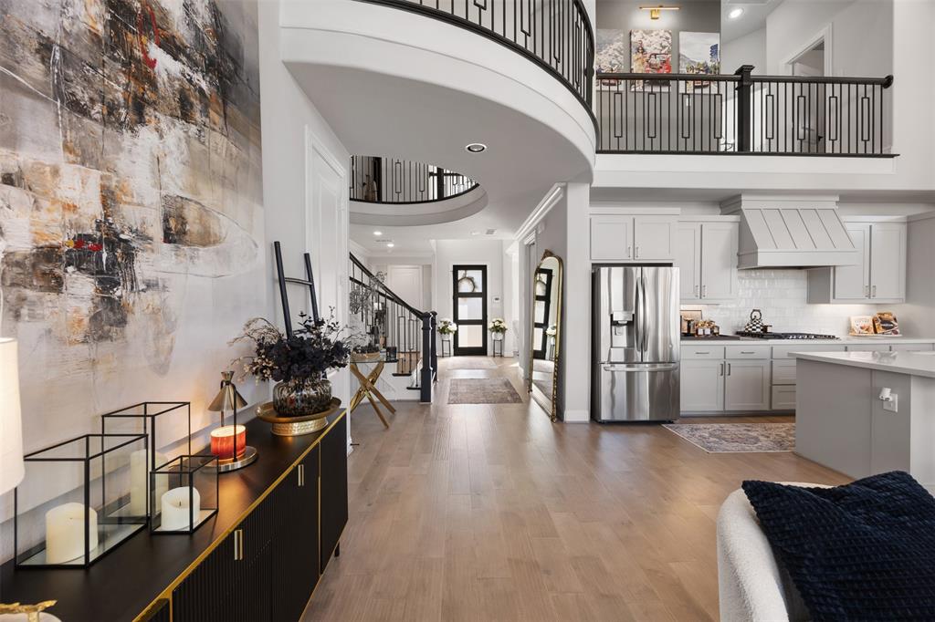 2413 Shane Drive Midlothian, TX 76065 - Photo 14 of 37 a view of a living room and entryway with wooden floor