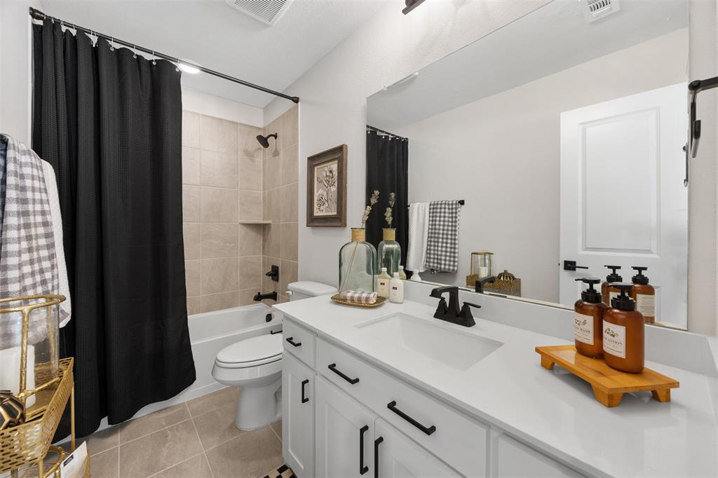 2413 Shane Drive Midlothian, TX 76065 - Photo 30 of 37 a bathroom with double vanity sinks a toilet a mirror and shower
