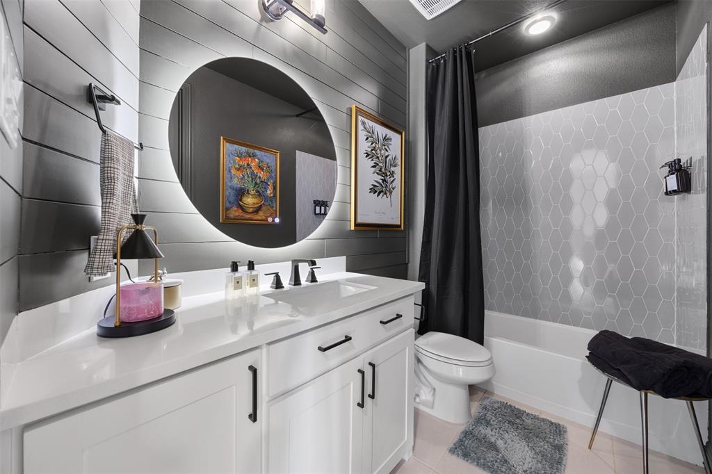 2413 Shane Drive Midlothian, TX 76065 - Photo 9 of 37 a bathroom with a toilet a sink and a mirror
