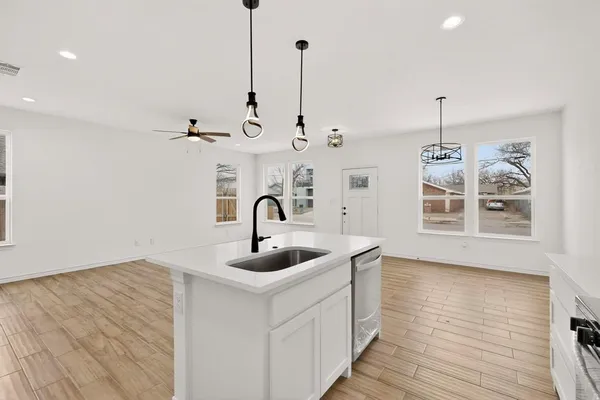 a kitchen with cabinets and steel appliances