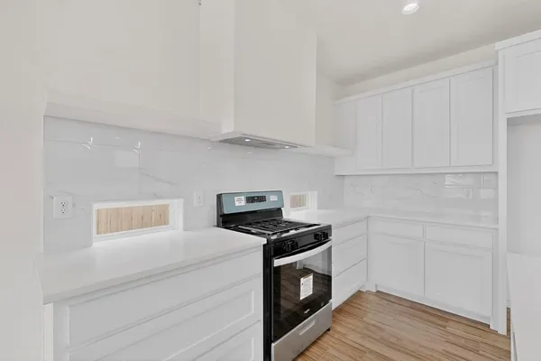 a kitchen with stainless steel appliances a stove a sink and a refrigerator