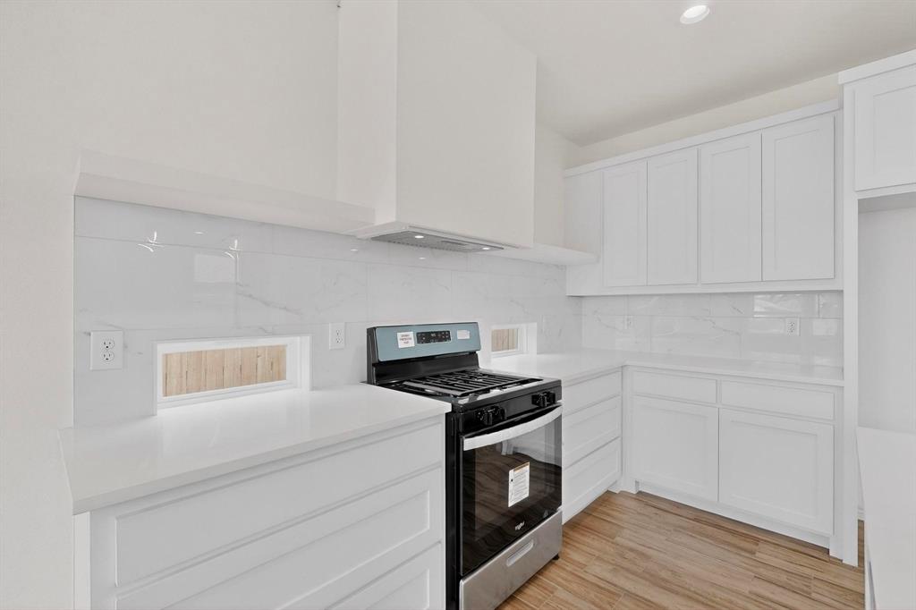 1610 Life Avenue Dallas, TX 75212 - Photo 14 of 38 a kitchen with cabinets and steel appliances
