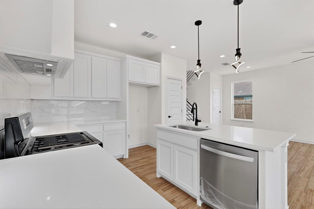 1610 Life Avenue Dallas, TX 75212 - Photo 15 of 38 a kitchen with stainless steel appliances a stove a sink and a refrigerator