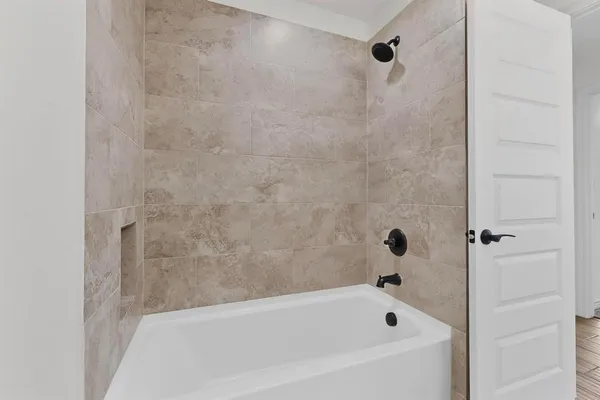 an empty room with ceiling fan and windows