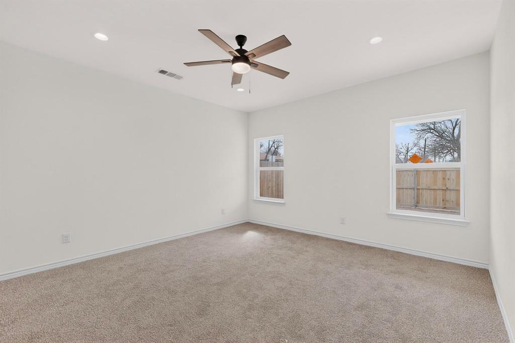 1610 Life Avenue Dallas, TX 75212 - Photo 19 of 38 an empty room with ceiling fan and windows