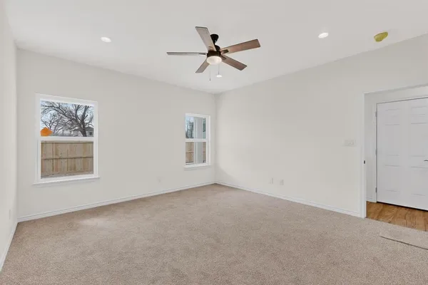 a view of a room with a ceiling fan