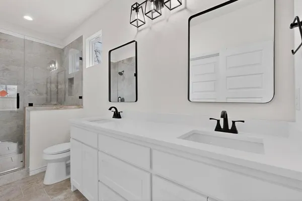 a bathroom with a sink a toilet and a mirror