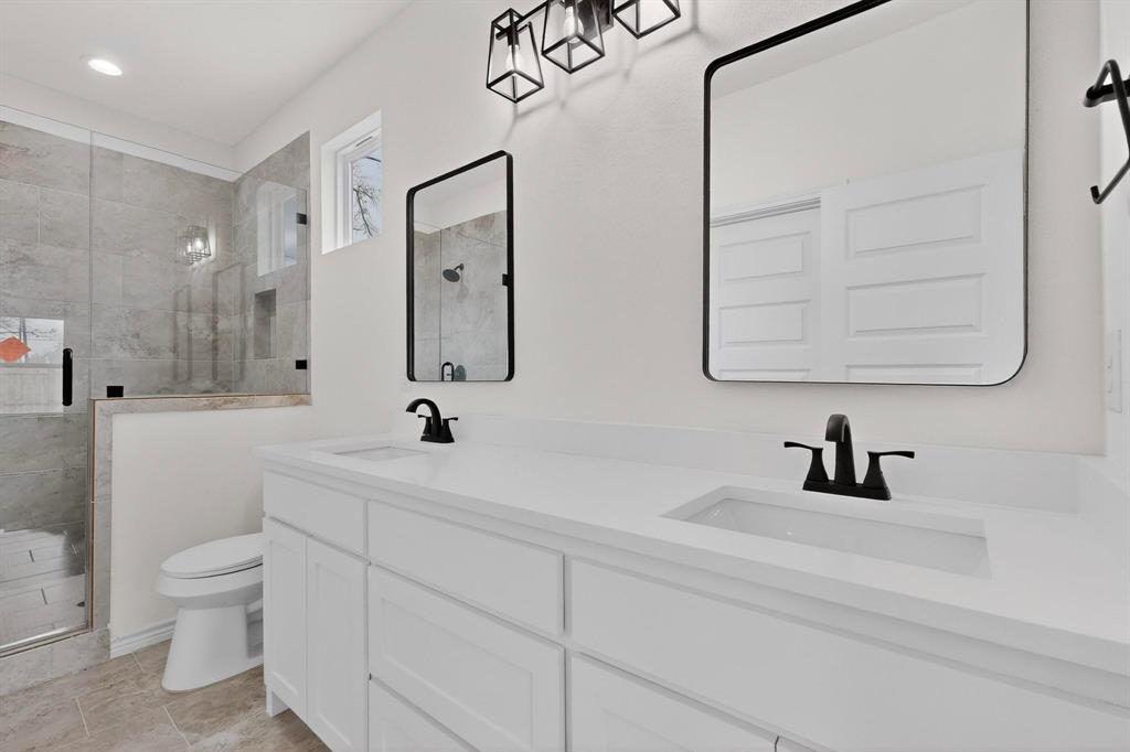 1610 Life Avenue Dallas, TX 75212 - Photo 23 of 38 a bathroom with a sink a toilet and a mirror