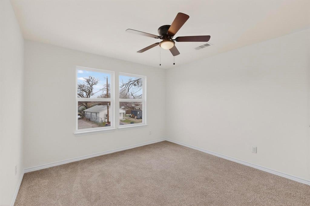 1610 Life Avenue Dallas, TX 75212 - Photo 26 of 38 an empty room with windows and fan