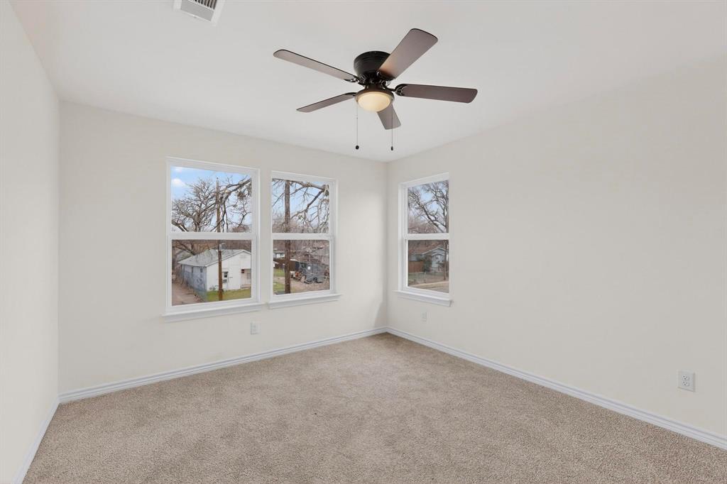 1610 Life Avenue Dallas, TX 75212 - Photo 28 of 38 an empty room with windows and fan