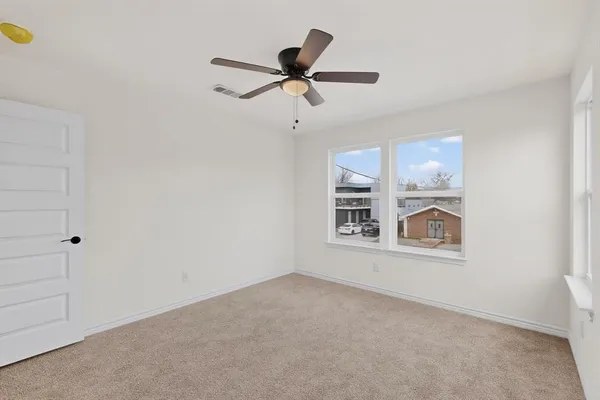 a view of empty room with ceiling fan