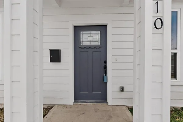 a view of staircase with wooden floor and white walls