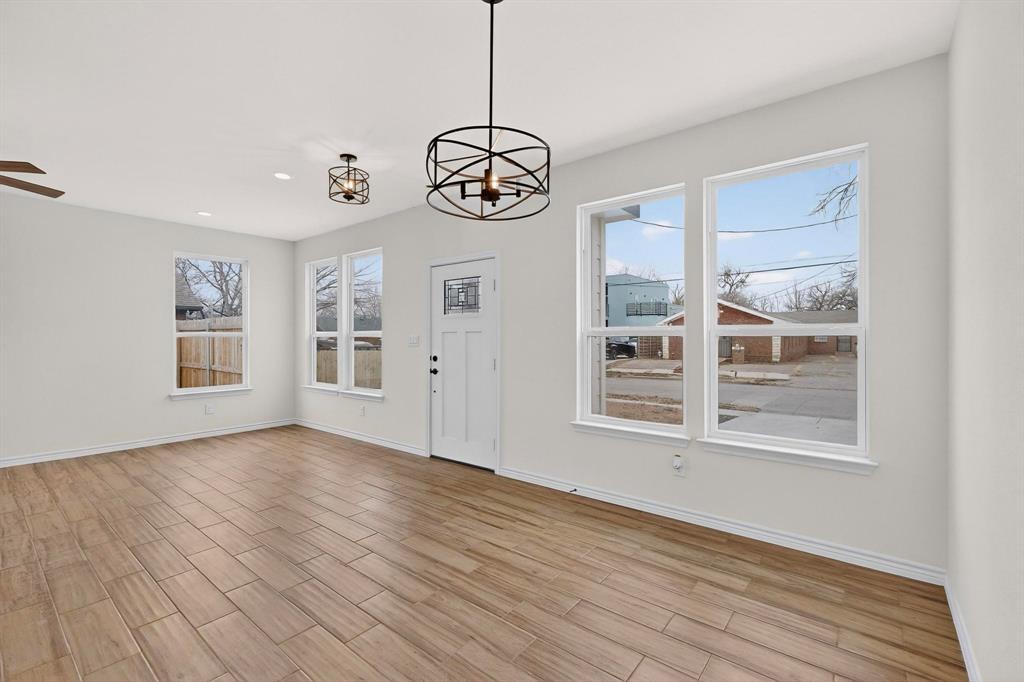 1610 Life Avenue Dallas, TX 75212 - Photo 7 of 38 a view of an empty room with a window and wooden floor
