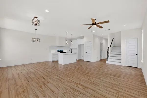 a view of kitchen with sink and wooden floor