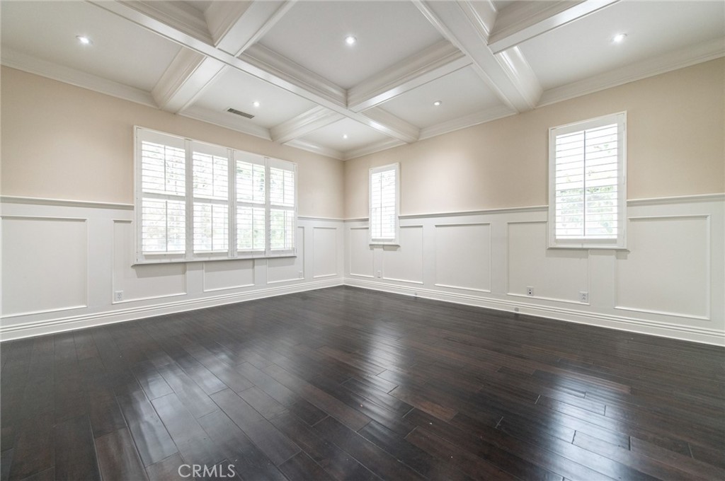 26 Secret Garden Irvine, CA 92620 - Photo 17 of 38 an empty room with wooden floor and windows with curtains