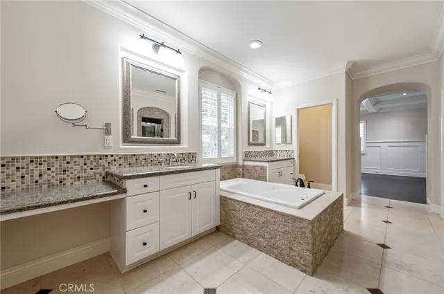 a bathroom with a tub sink and mirror