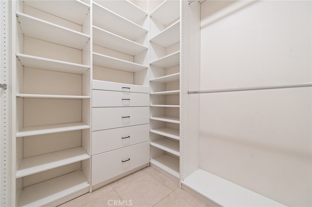 26 Secret Garden Irvine, CA 92620 - Photo 23 of 38 a view of walk in closet with empty racks